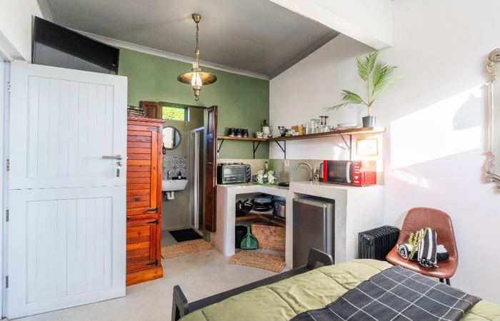 Double bed and self-catering kitchenette in Olive Studio