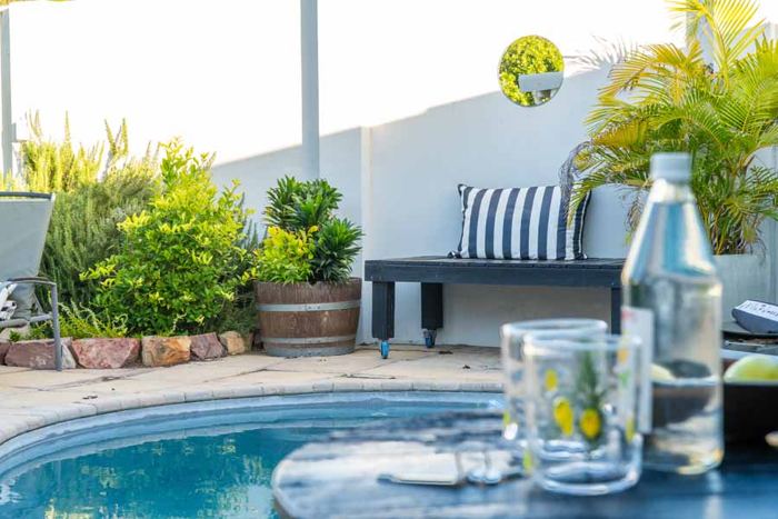 Pool-side seating with palm trees