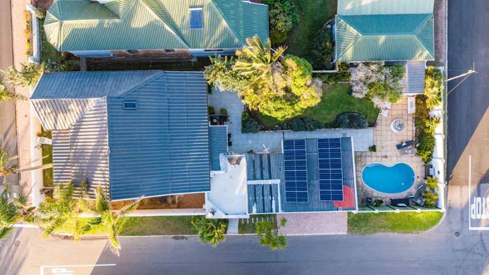 Top-down aerial view of the Villa Palmera pool, garden and solar roof
