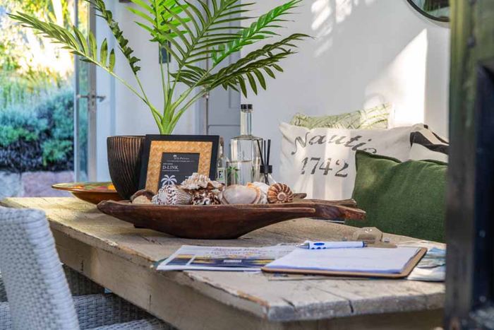 Welcome table with shells, guestbook and local guides
